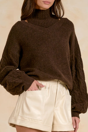 Peekaboo turtleneck sweater with braided Sleeves